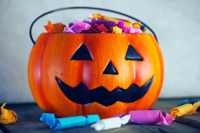 Pumpkin-with-candy-on-gray-background